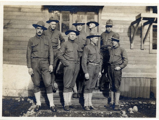 Colby E. "Babe" Slater and other soldiers by building, circa 1918 Babe is second from left in back row.